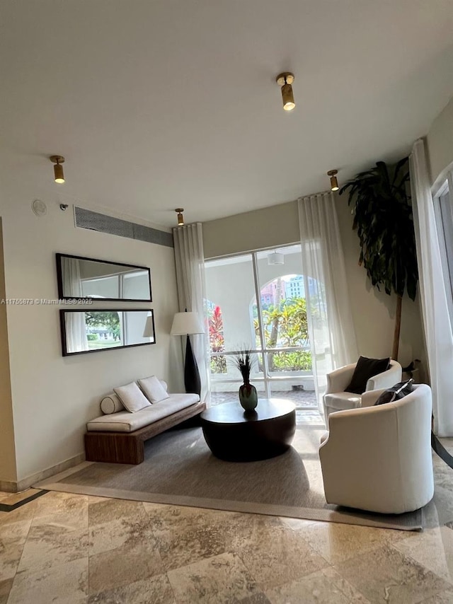 2351 Douglas Rd Unit 1109, Miami, FL 33145 - living area with healthy amount of natural light and stone finish floors