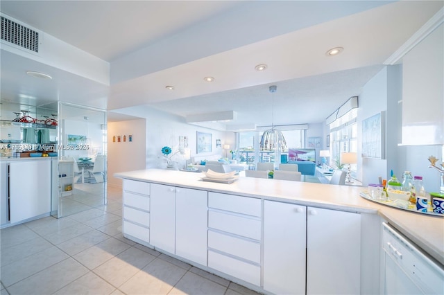 kitchen with recessed lighting, white cabinets, open floor plan, light countertops, and dishwasher