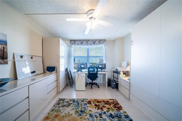 home office with ceiling fan and a textured ceiling