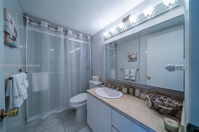 full bath with toilet, tile patterned floors, curtained shower, vanity, and tile walls