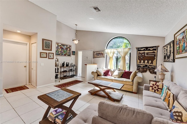 living room featuring visible vents, a textured ceiling, and light tile patterned flooring