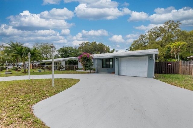 view of front facade with concrete driveway, a front lawn, and an attached garage