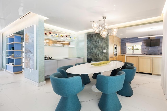dining room with an inviting chandelier and marble finish floor