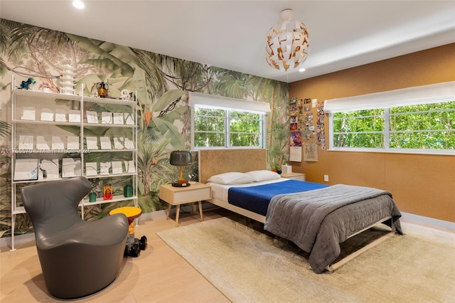 bedroom with wood finished floors and recessed lighting