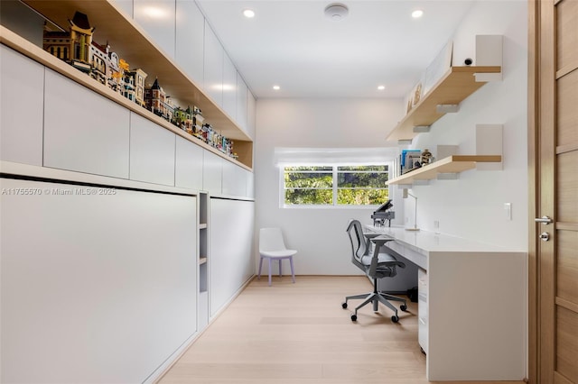 office featuring recessed lighting, light wood-style flooring, and built in study area