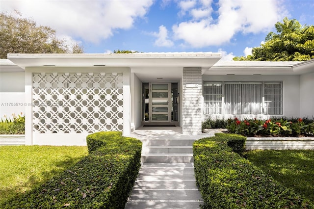 entrance to property with a yard