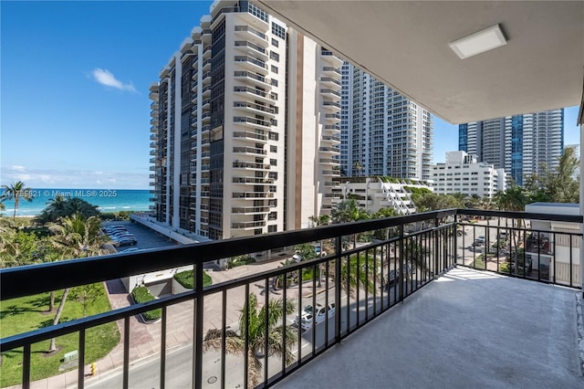 balcony with a water view and a view of city