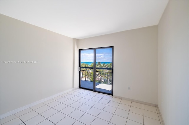 unfurnished room with baseboards and light tile patterned floors