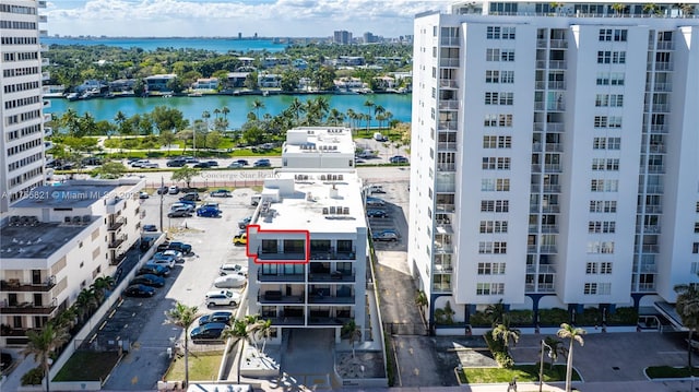 birds eye view of property with a water view and a city view