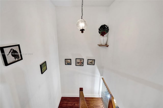 stairs featuring baseboards and wood finished floors