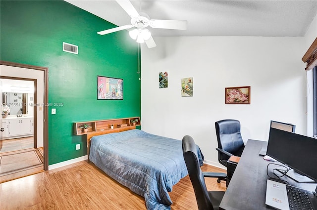 bedroom featuring baseboards, visible vents, ceiling fan, wood finished floors, and vaulted ceiling