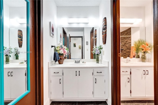 bathroom with two vanities and a sink