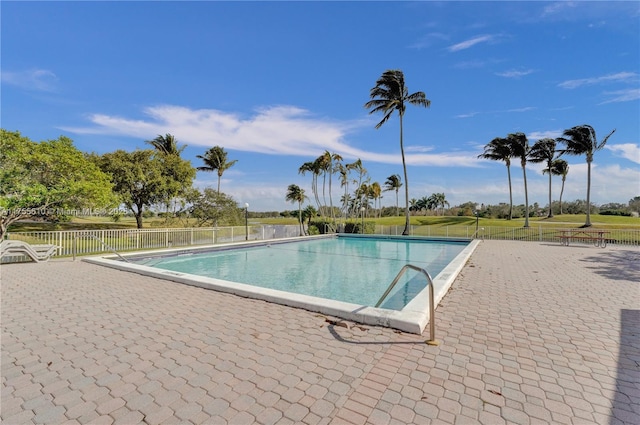 pool featuring a patio area and fence