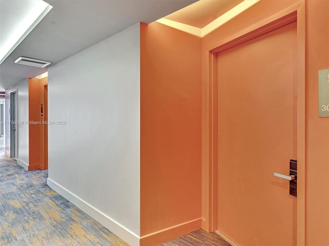 hallway featuring visible vents and baseboards