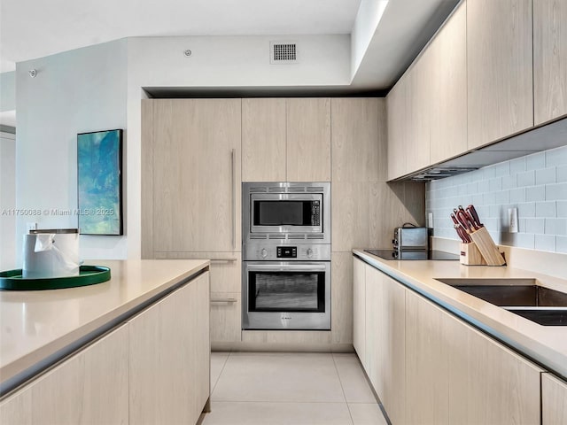 kitchen featuring light countertops, appliances with stainless steel finishes, and visible vents