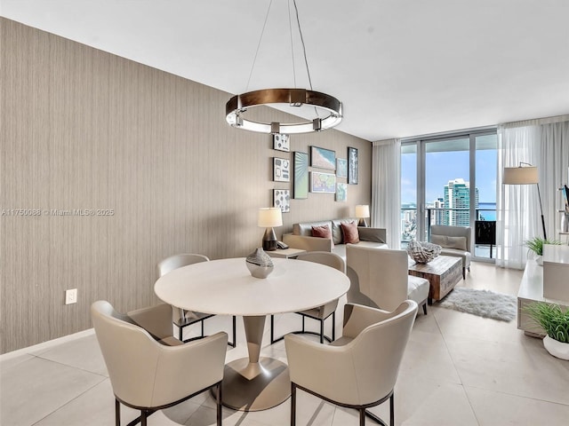 dining space with a view of city, expansive windows, and light tile patterned flooring