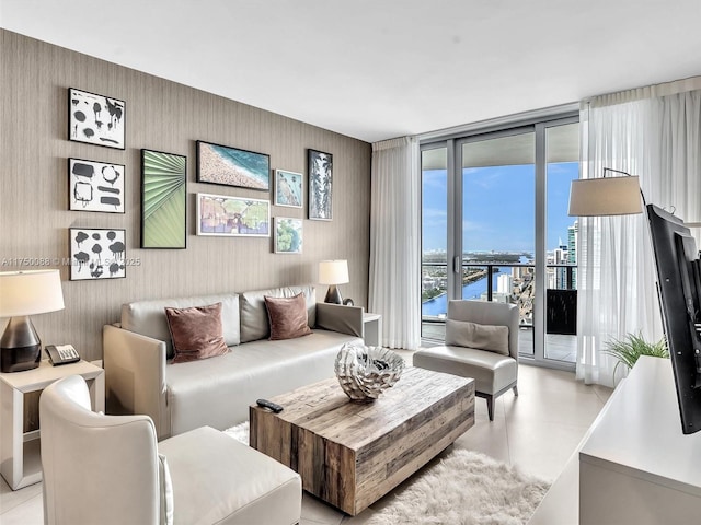 living area featuring expansive windows and light tile patterned flooring