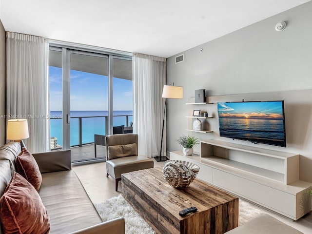 tiled living room with floor to ceiling windows and visible vents