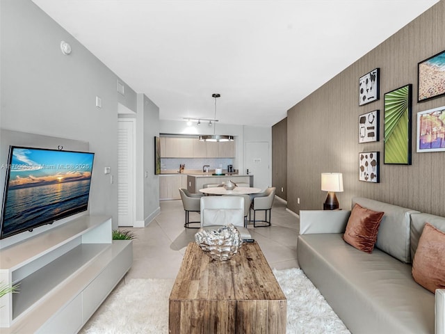 living room with an accent wall and baseboards