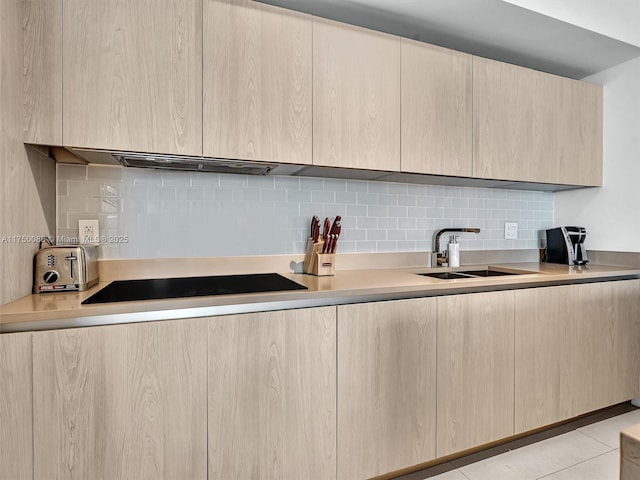 kitchen featuring light countertops, light brown cabinets, and modern cabinets