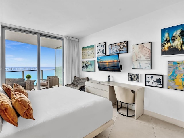 bedroom with light tile patterned floors, expansive windows, baseboards, and access to exterior