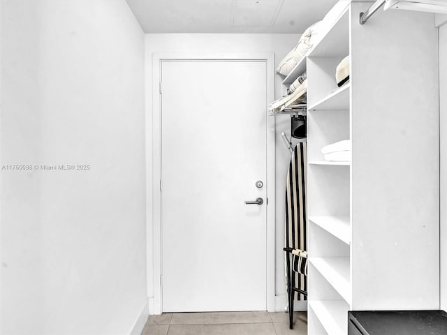 spacious closet featuring light tile patterned floors