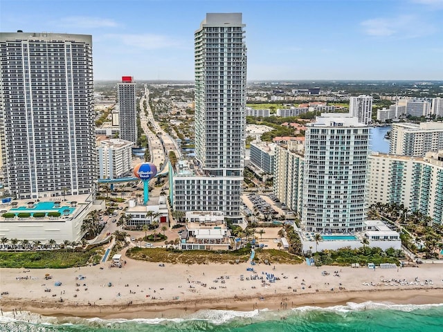 property's view of city featuring a water view and a beach view