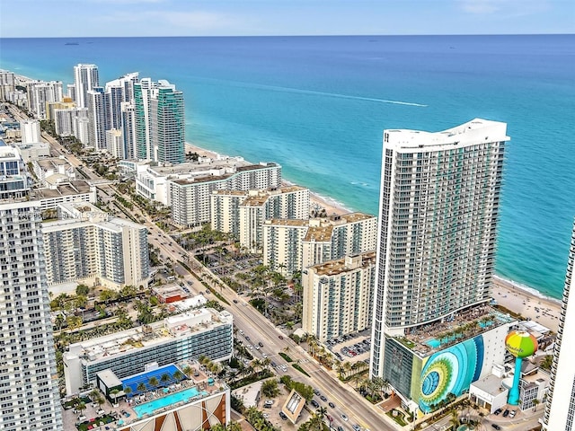 birds eye view of property with a water view and a city view