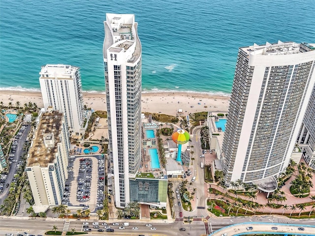 birds eye view of property with a water view, a city view, and a view of the beach