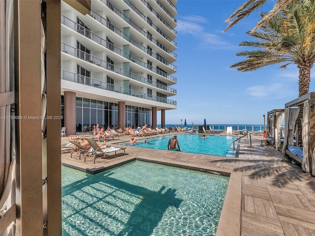 pool with a water view and a patio