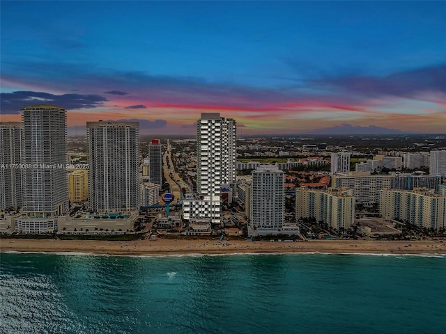 property's view of city with a water view and a beach view