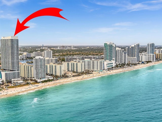 exterior space featuring a view of city, a water view, and a beach view