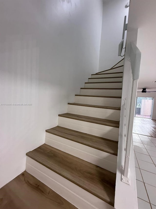 staircase featuring tile patterned flooring