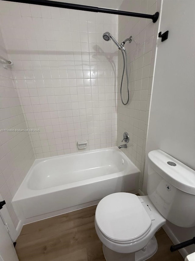 full bath with toilet, shower / bath combination, and wood finished floors