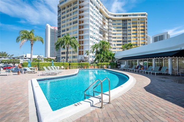 pool with fence and a patio