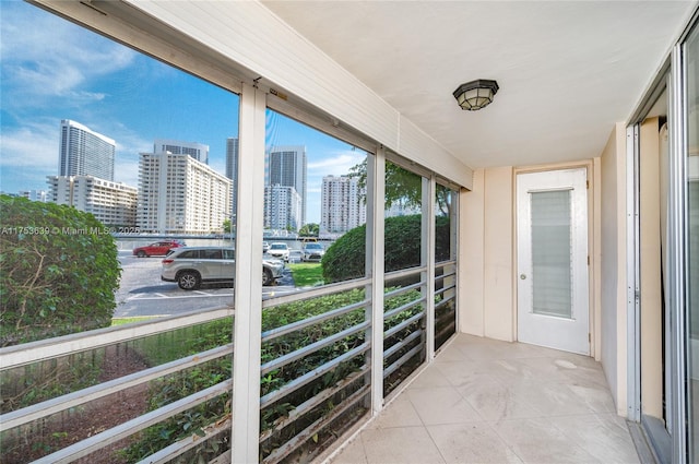 unfurnished sunroom featuring a city view