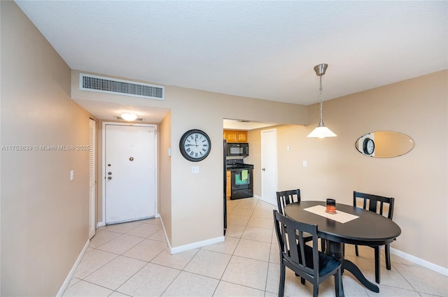 dining room featuring light tile patterned floors, baseboards, and visible vents