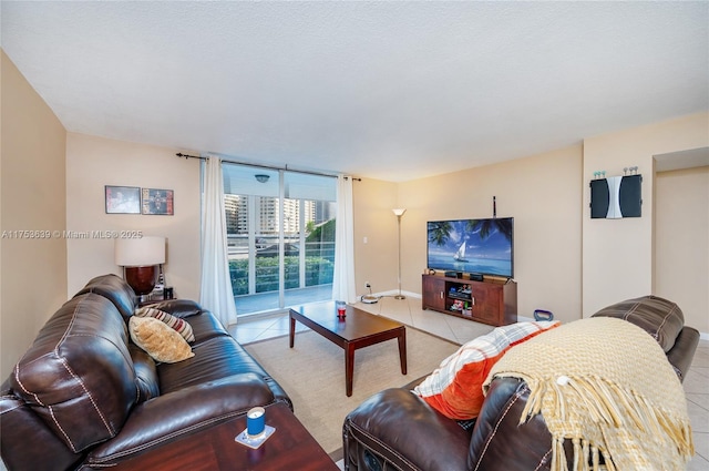 living room featuring floor to ceiling windows and light tile patterned flooring