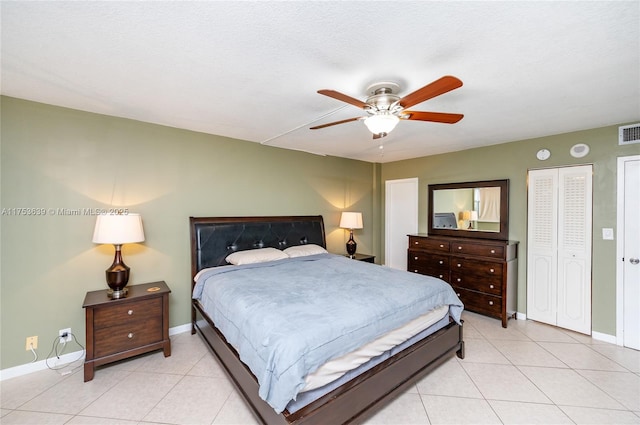 bedroom featuring visible vents, ceiling fan, baseboards, and light tile patterned flooring