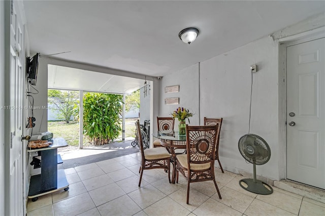 dining room with expansive windows and light tile patterned flooring