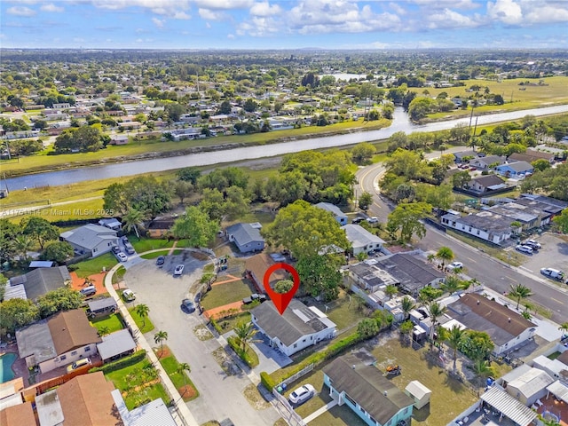 bird's eye view featuring a water view and a residential view