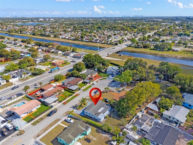 drone / aerial view featuring a residential view and a water view