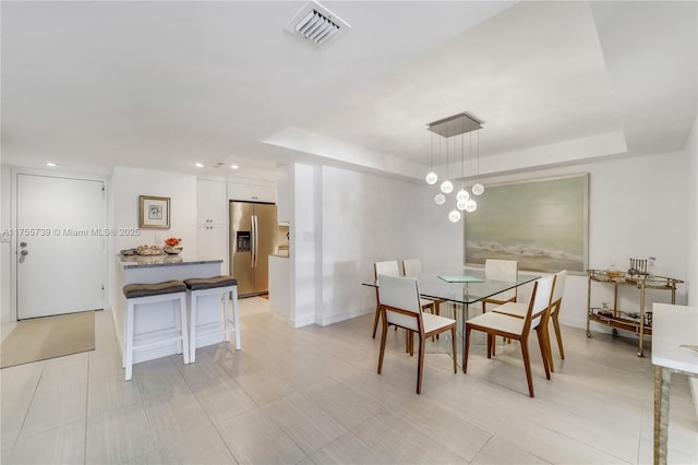 dining room with recessed lighting, a raised ceiling, visible vents, and baseboards