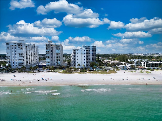 aerial view with a city view, a beach view, and a water view