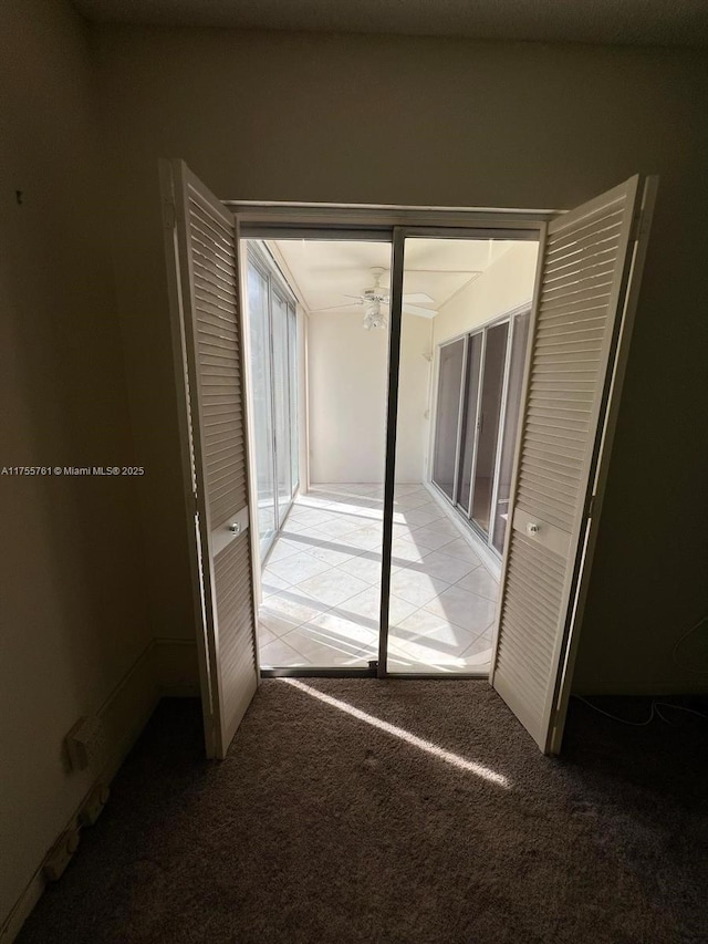 interior space with light carpet and light tile patterned flooring