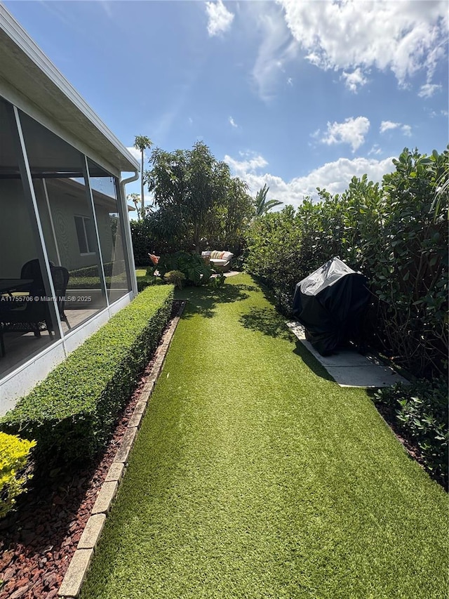 view of yard with a sunroom