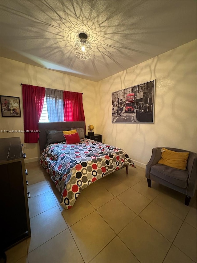 bedroom featuring baseboards and tile patterned floors