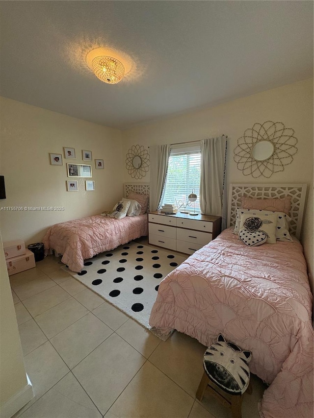 bedroom featuring light tile patterned floors