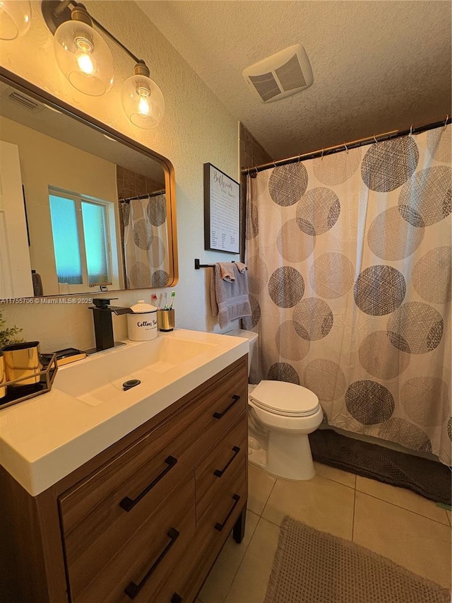 full bath with visible vents, toilet, a textured ceiling, vanity, and tile patterned flooring