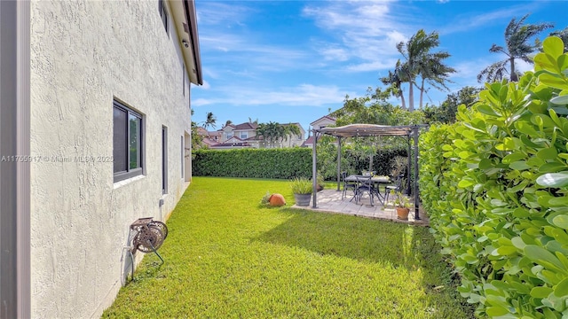 view of yard featuring a patio, fence, and a pergola